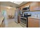 Kitchen with stainless steel appliances, granite counters, and light wood cabinets at 4015 11Th W Ave, Bradenton, FL 34205