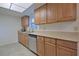 Bright kitchen with long granite counters and ample cabinet space, and stainless steel dishwasher at 4015 11Th W Ave, Bradenton, FL 34205