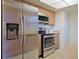 Kitchen featuring stainless steel refrigerator, microwave, and range with light wood cabinets at 4015 11Th W Ave, Bradenton, FL 34205