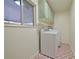 Functional laundry room with shelving and bright patterned tile floor at 4015 11Th W Ave, Bradenton, FL 34205