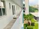 View of condo's walkway to unit 302, overlooking the landscaped grounds at 4240 Ironwood Cir # 302A, Bradenton, FL 34209