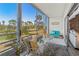 Cozy screened-in balcony with comfortable seating and a scenic view of the golf course at 4240 Ironwood Cir # 302A, Bradenton, FL 34209