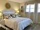 Comfortable bedroom with a queen size bed, seaside decorations, and lots of natural light from the bright windows at 4240 Ironwood Cir # 302A, Bradenton, FL 34209