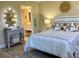 Bedroom features a bright vanity with oval mirror next to the bed that has stylish seaside decor at 4240 Ironwood Cir # 302A, Bradenton, FL 34209