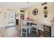 Cozy dining area featuring stylish decor, a round table, and an entryway with a screen door at 4240 Ironwood Cir # 302A, Bradenton, FL 34209