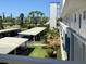 View of covered parking spaces and well-kept landscaping from a higher floor at 4240 Ironwood Cir # 302A, Bradenton, FL 34209