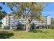 Building exterior showcasing well-maintained landscaping, parking, and a view of the condo's balconies at 4240 Ironwood Cir # 302A, Bradenton, FL 34209