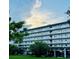 Multi-story condo building with balconies and covered parking on a lush green lawn at 4240 Ironwood Cir # 302A, Bradenton, FL 34209