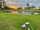 Picturesque golf course at sunset, featuring a serene pond reflecting the vibrant sky at 4240 Ironwood Cir # 302A, Bradenton, FL 34209