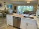 Open kitchen with stainless steel appliances and a breakfast bar overlooking the living room area at 4240 Ironwood Cir # 302A, Bradenton, FL 34209