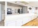 Community kitchenette with white cabinetry, stainless steel appliances, and wood flooring at 4240 Ironwood Cir # 302A, Bradenton, FL 34209