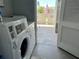 Well-equipped laundry room featuring modern washer and dryer, with an outdoor view at 4240 Ironwood Cir # 302A, Bradenton, FL 34209