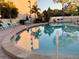 Community pool with lounge chairs, tables, and well-maintained landscaping at 4240 Ironwood Cir # 302A, Bradenton, FL 34209