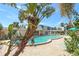 Community pool with lounge chairs and lush tropical foliage at 4240 Ironwood Cir # 302A, Bradenton, FL 34209