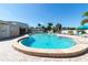 Resort-style community pool with lounge chairs and palm trees under a clear blue sky at 4240 Ironwood Cir # 302A, Bradenton, FL 34209