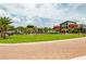 Community green space with palm trees, a splash pad, and sidewalks for residents to enjoy at 44234 Creekside Run Ln, Punta Gorda, FL 33982