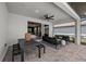 Covered patio with elegant outdoor seating and a dining area, leading to an open living space at 44234 Creekside Run Ln, Punta Gorda, FL 33982