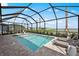 Enclosed screened pool boasts clear water, lounge chairs, and scenic backyard views at 44234 Creekside Run Ln, Punta Gorda, FL 33982