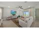 Comfortable living room featuring a large sofa, accent pillows, and modern decor at 44240 Creekside Run Ln, Punta Gorda, FL 33982
