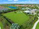 Aerial view of a community dog park, amenity center, and neighborhood at 4717 Zeno Ct, Bradenton, FL 34211