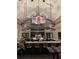 Well-lit bar and lounge area with multiple TVs, bartender, table seating and elegant lighting at 4717 Zeno Ct, Bradenton, FL 34211