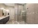 The remodeled bathroom features a spacious glass-enclosed shower, dual showerheads, and stylish fixtures at 4717 Zeno Ct, Bradenton, FL 34211