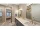 This remodeled bathroom features dual sinks, stylish fixtures, and a glass-enclosed shower for a luxurious feel at 4717 Zeno Ct, Bradenton, FL 34211