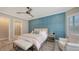This bedroom features a stylish accent wall, ceiling fan, and an ensuite bathroom with a glass-enclosed shower at 4717 Zeno Ct, Bradenton, FL 34211