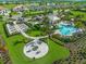 Aerial view of community pool, fire pit and garden surrounded by lush landscaping at 4717 Zeno Ct, Bradenton, FL 34211