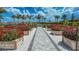 Community garden with walking path and flower boxes under blue skies at 4717 Zeno Ct, Bradenton, FL 34211