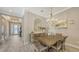 Formal dining room with elegant chandelier, wood table with seating for six, and decorative accents at 4717 Zeno Ct, Bradenton, FL 34211