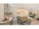 Elegant dining room featuring a wooden table, decorative mirror, and modern chandelier at 4717 Zeno Ct, Bradenton, FL 34211