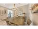 Inviting dining room with a decorative chandelier, neutral tones, and access to the study at 4717 Zeno Ct, Bradenton, FL 34211
