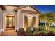 Front entry with stone elevation, decorative window and door, and manicured shrubs at 4717 Zeno Ct, Bradenton, FL 34211