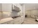 Modern kitchen features white cabinets, granite countertops, stylish backsplash and stainless steel appliances at 4717 Zeno Ct, Bradenton, FL 34211