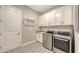This laundry room features modern appliances, ample cabinet space, and patterned tile flooring at 4717 Zeno Ct, Bradenton, FL 34211