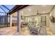 The screened patio offers a summer kitchen, dining and sitting areas, seamlessly merging indoor and outdoor living at 4717 Zeno Ct, Bradenton, FL 34211