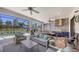 Inviting outdoor living space with a full kitchen, dining area, comfortable seating, and a view of the pool at 4717 Zeno Ct, Bradenton, FL 34211