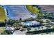 Aerial view of community pool with seating surrounded by lush landscaping and lake at 4717 Zeno Ct, Bradenton, FL 34211