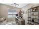 Comfortable study features a ceiling fan, shelving, natural light, and wood-style flooring at 4717 Zeno Ct, Bradenton, FL 34211