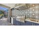 The outdoor kitchen features a stainless steel grill, fridge, and modern vent hood at 4717 Zeno Ct, Bradenton, FL 34211