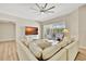 Bright living room with a ceiling fan, patio access, and modern furnishings at 4724 White Tail Ln, Sarasota, FL 34238