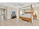 Spacious main bedroom with hardwood floors and a large dresser with a mounted TV at 4724 White Tail Ln, Sarasota, FL 34238