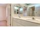 Bathroom featuring a double sink vanity with a mirror and a view into the adjacent shower at 4745 Antler Trl Trl, Sarasota, FL 34238