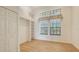 Bright bedroom featuring laminate wood flooring, built-in shelving, and windows at 4745 Antler Trl Trl, Sarasota, FL 34238
