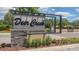 Deer Creek on Palmer Ranch community sign with decorative stone and colorful flowers at 4745 Antler Trl Trl, Sarasota, FL 34238