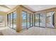 Bright sunroom featuring large windows with views of the pool and a tiled floor at 4745 Antler Trl Trl, Sarasota, FL 34238