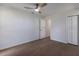This bedroom features light wood floors, a modern ceiling fan, closet, and an open doorway at 5011 Live Oak Cir # 65, Bradenton, FL 34207