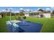 Outdoor community area with tables, benches, and a grill; a laundry room in the background at 5011 Live Oak Cir # 65, Bradenton, FL 34207