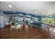 Large community room with tables, chairs, sofas, a ping pong table and plenty of natural light at 5011 Live Oak Cir # 65, Bradenton, FL 34207